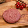 Close up of raw Kingsbury Wagyu Beef Burger on a chopping board